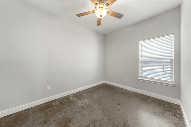 unfurnished room with ceiling fan and concrete floors