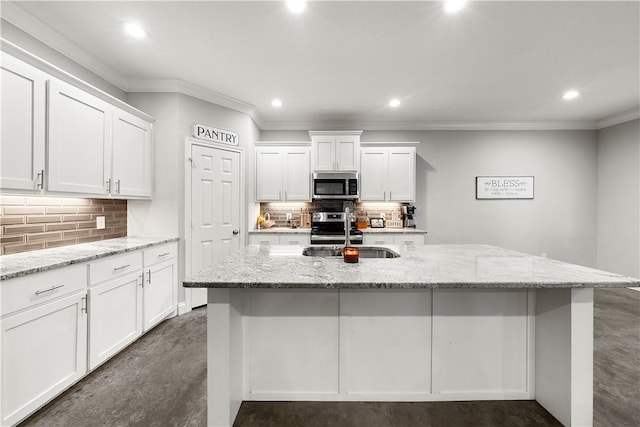 kitchen featuring white cabinetry, stainless steel appliances, sink, and light stone counters