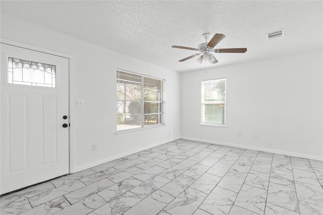 entryway with a textured ceiling and ceiling fan