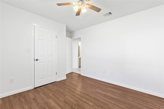 spare room with ceiling fan and dark hardwood / wood-style flooring