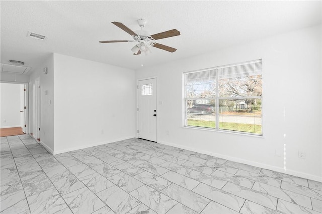 entryway featuring a textured ceiling and ceiling fan