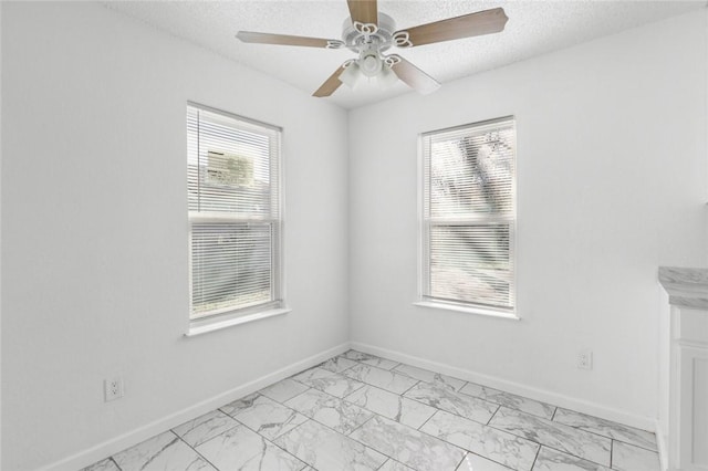 unfurnished room featuring a textured ceiling and ceiling fan