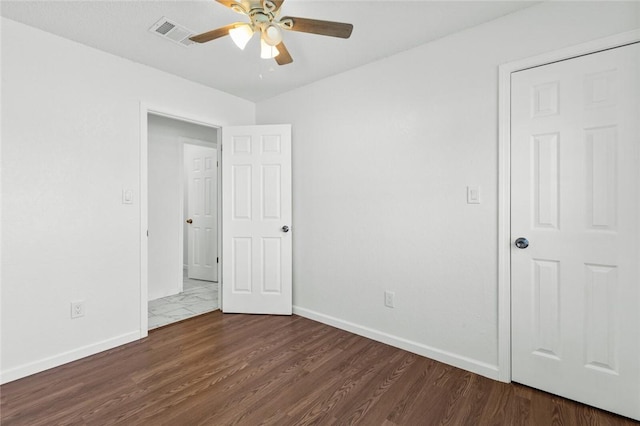 unfurnished bedroom featuring ceiling fan and dark wood-type flooring