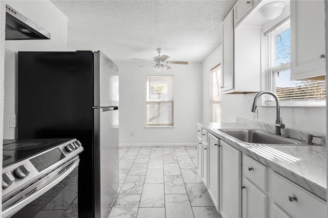 kitchen featuring white cabinets, plenty of natural light, electric stove, and sink