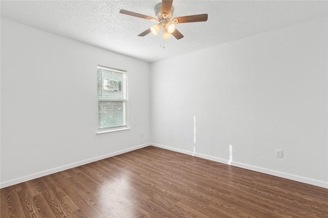 spare room with ceiling fan, dark wood-type flooring, and a textured ceiling