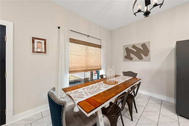 dining space featuring an inviting chandelier