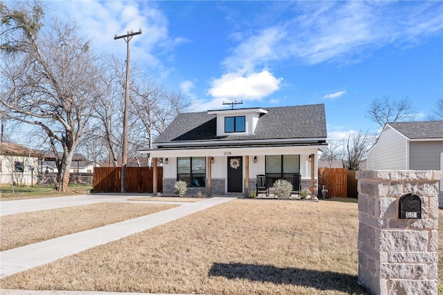 view of front of home with a front yard and covered porch