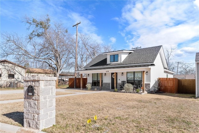 view of front of property with a porch and a front lawn