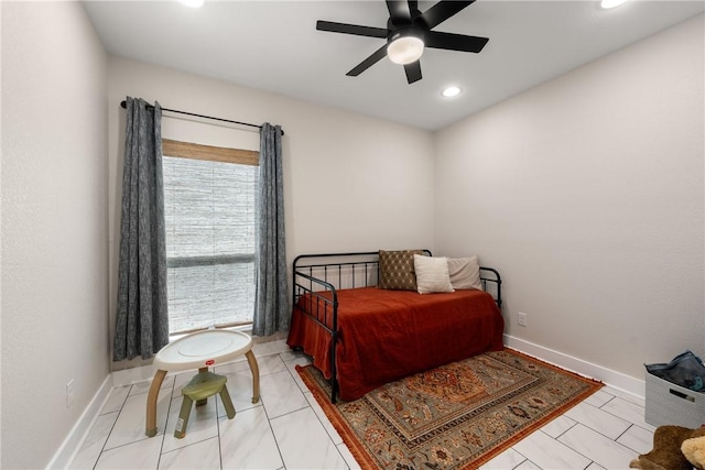 tiled bedroom featuring ceiling fan