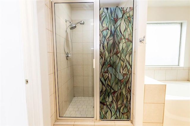 full bathroom with a shower stall and a garden tub