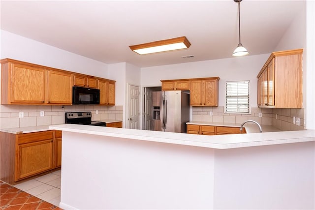 kitchen featuring visible vents, light countertops, light tile patterned floors, appliances with stainless steel finishes, and a peninsula