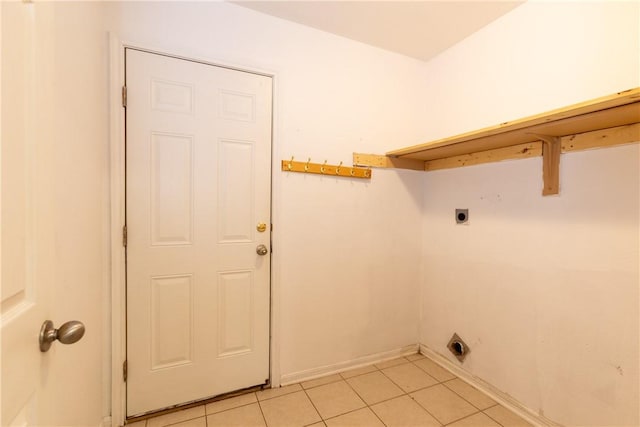 clothes washing area with laundry area, light tile patterned floors, baseboards, and electric dryer hookup