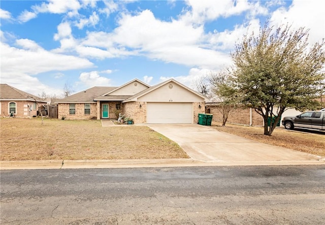 single story home with brick siding, driveway, an attached garage, and a front lawn