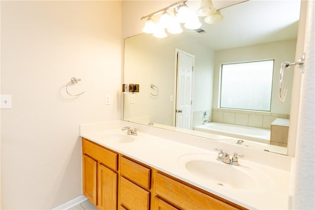 bathroom featuring double vanity, a bath, visible vents, and a sink