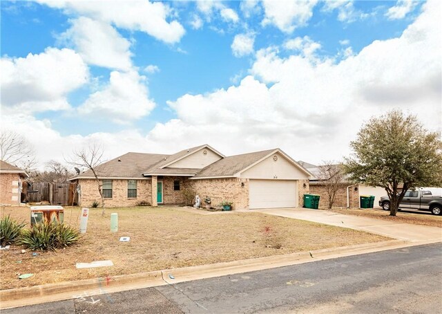 ranch-style house with a garage, brick siding, driveway, and fence