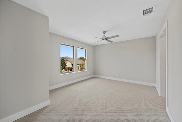 spare room with light carpet and ceiling fan