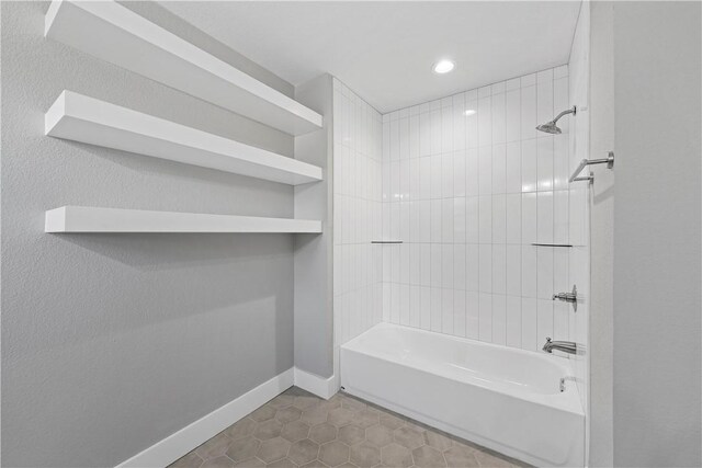 bathroom featuring tiled shower / bath and tile patterned flooring