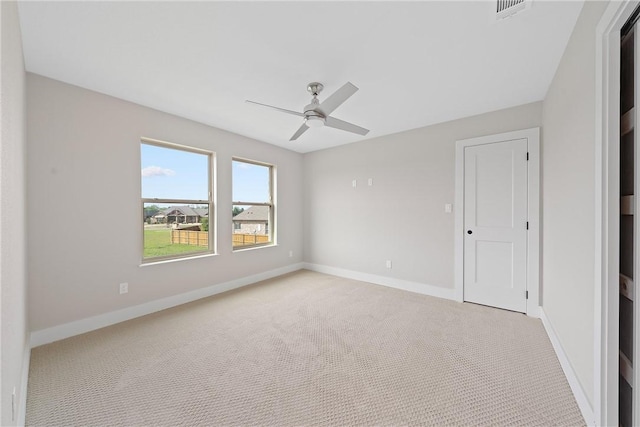 unfurnished room with ceiling fan and light colored carpet