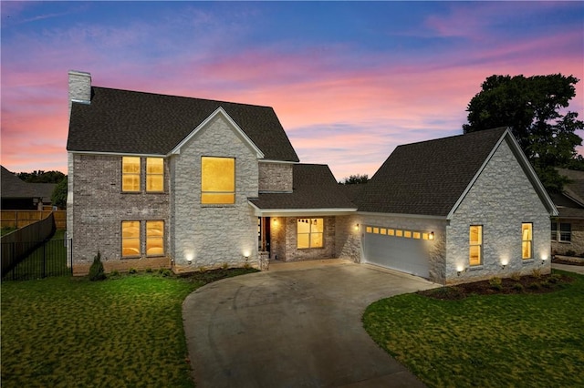 view of front of home featuring a garage and a lawn