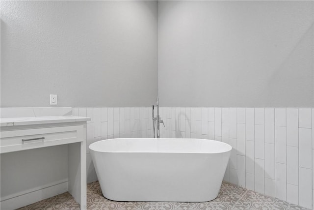 bathroom featuring a tub and vanity