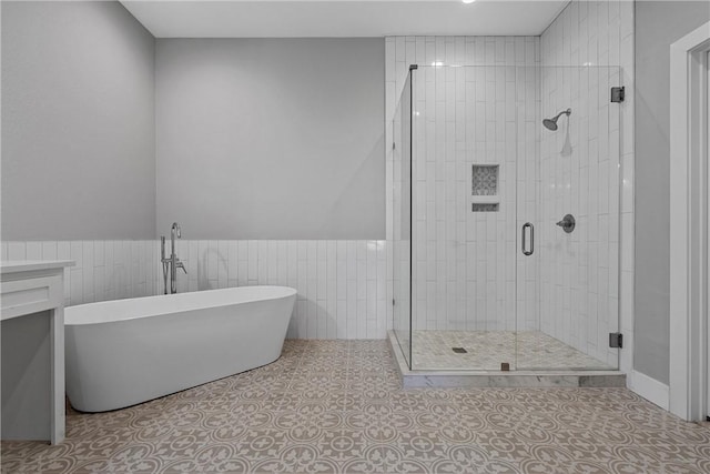 bathroom with tile patterned floors and independent shower and bath