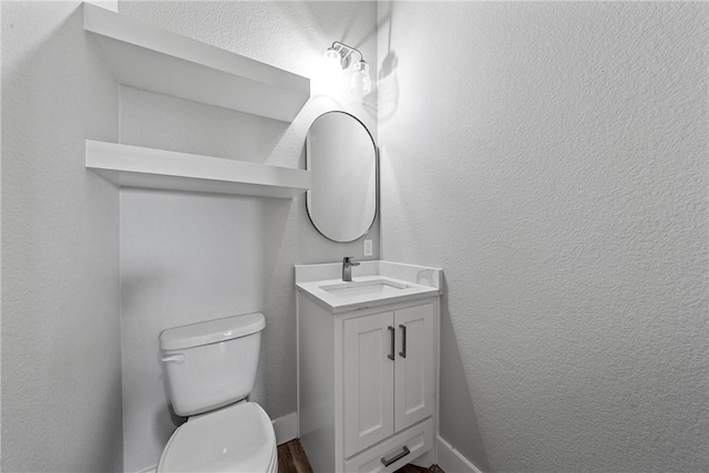 bathroom with toilet and vanity