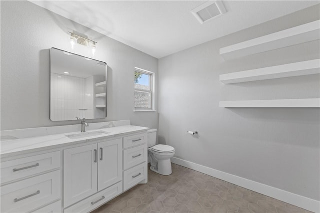 bathroom featuring toilet, tile patterned flooring, and vanity