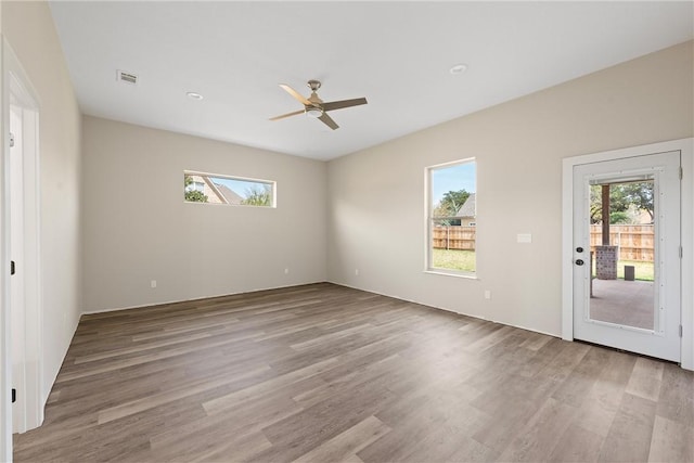 empty room with light wood-type flooring and ceiling fan