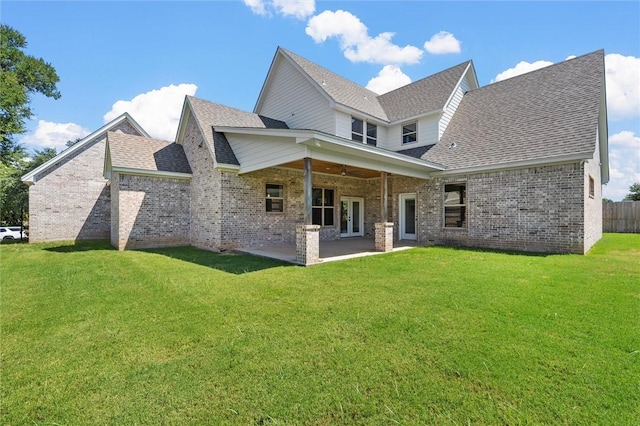 rear view of house with a patio area and a yard