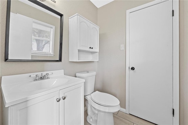 bathroom featuring toilet, vanity, and tile patterned floors