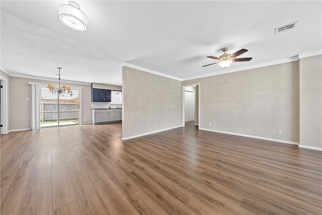 unfurnished living room with a textured ceiling, crown molding, dark wood-type flooring, and ceiling fan with notable chandelier