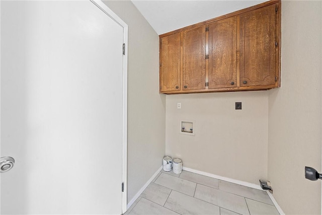 laundry area featuring electric dryer hookup, cabinets, light tile patterned floors, and hookup for a washing machine