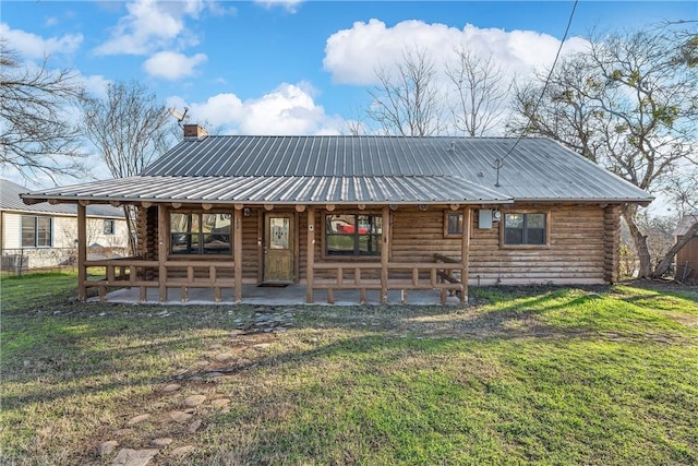 rear view of property with a patio area and a lawn