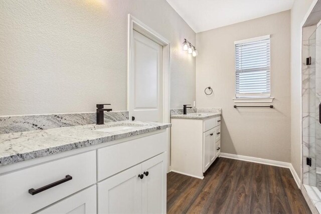 bathroom with a shower with door, vanity, and hardwood / wood-style flooring