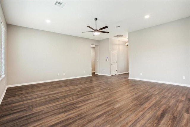 spare room featuring ceiling fan and dark wood-type flooring