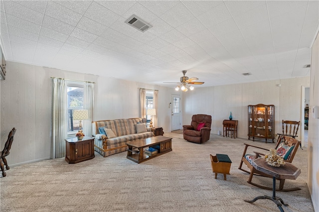 living room featuring light carpet and ceiling fan