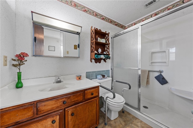 bathroom featuring vanity, walk in shower, toilet, tile patterned floors, and a textured ceiling