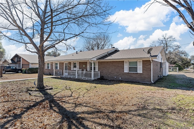 ranch-style home featuring a porch and a front lawn