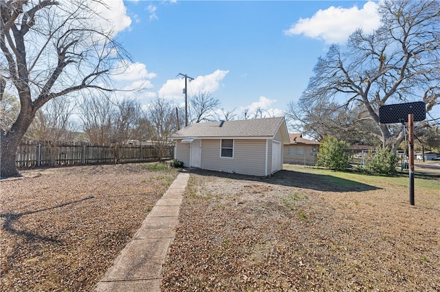 back of property with an outbuilding and a lawn