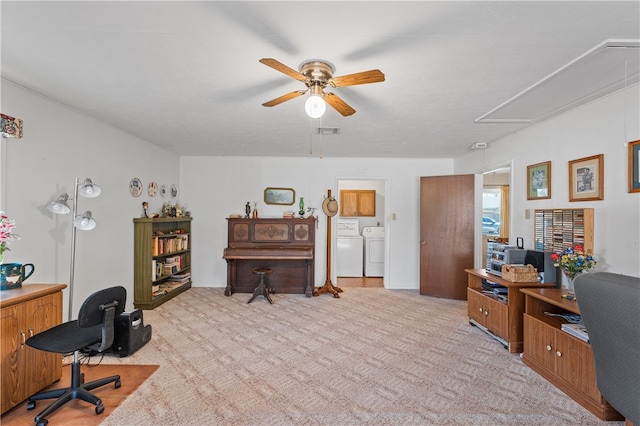 office space featuring ceiling fan, independent washer and dryer, and light carpet