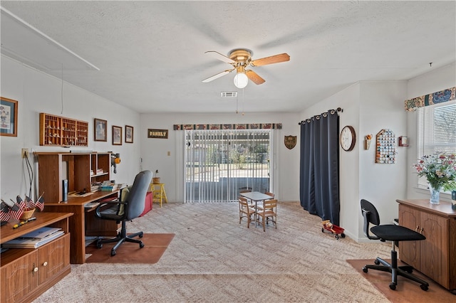 home office with ceiling fan, light carpet, and a textured ceiling