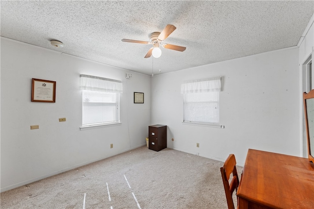 carpeted empty room featuring a textured ceiling and ceiling fan