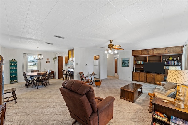 living room featuring light colored carpet and ceiling fan with notable chandelier