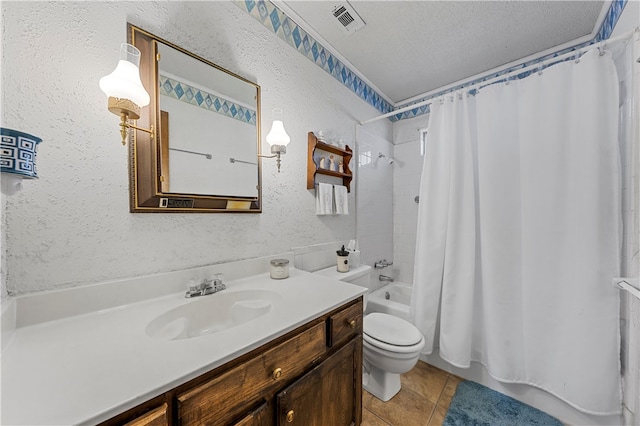 full bathroom featuring tile patterned flooring, vanity, a textured ceiling, toilet, and shower / bath combo with shower curtain