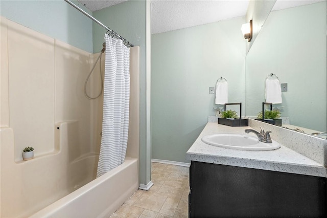 bathroom with a textured ceiling, tile patterned flooring, vanity, and shower / bath combo