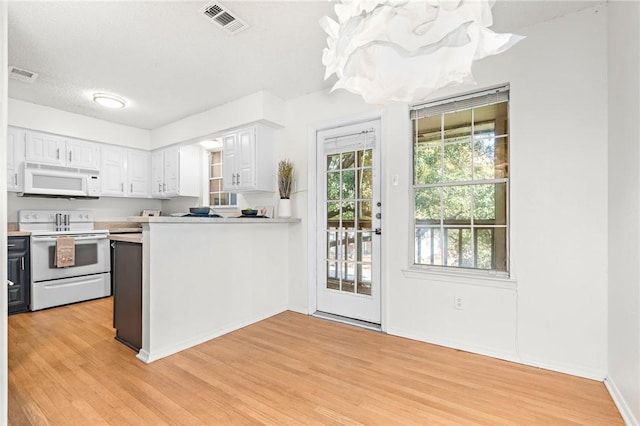 kitchen featuring white cabinetry, light hardwood / wood-style flooring, kitchen peninsula, a textured ceiling, and white appliances