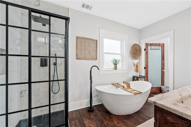 bathroom with vanity, hardwood / wood-style floors, and independent shower and bath