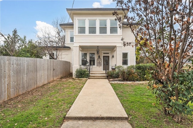 view of front facade with a porch and a front lawn