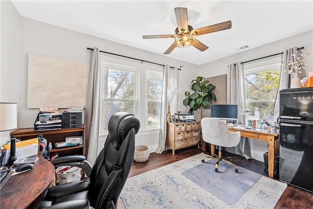 office with dark hardwood / wood-style floors and ceiling fan