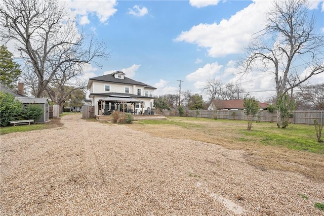 rear view of property with a gazebo and a deck